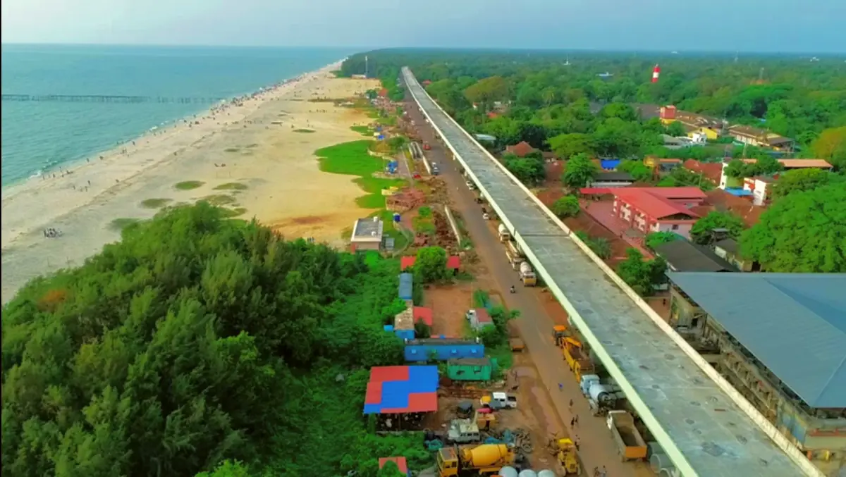 Aerial view of the Alappuzha bypass beside the coast with beach and green trees