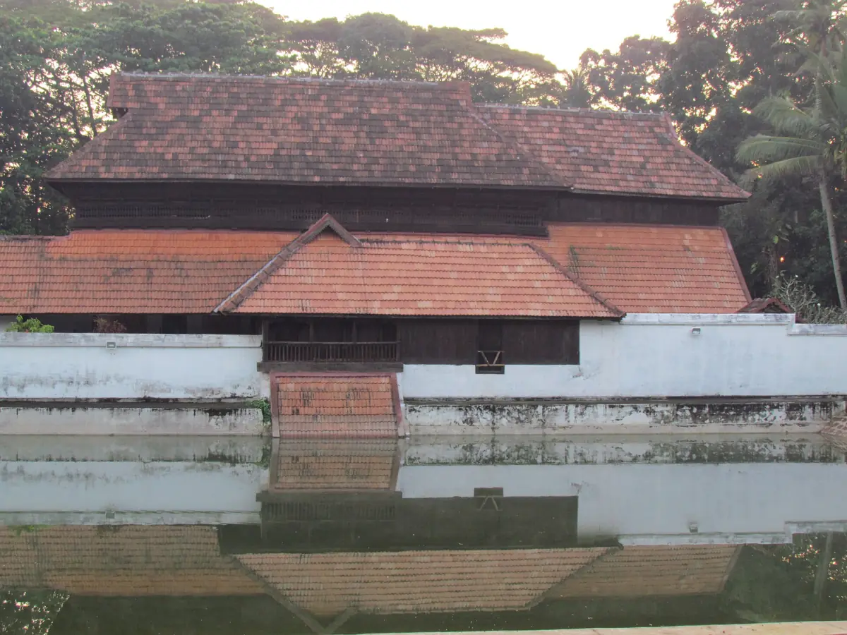 Krishnapuram Palace with its layered tiled roof reflected in the pond at Kayamkulam